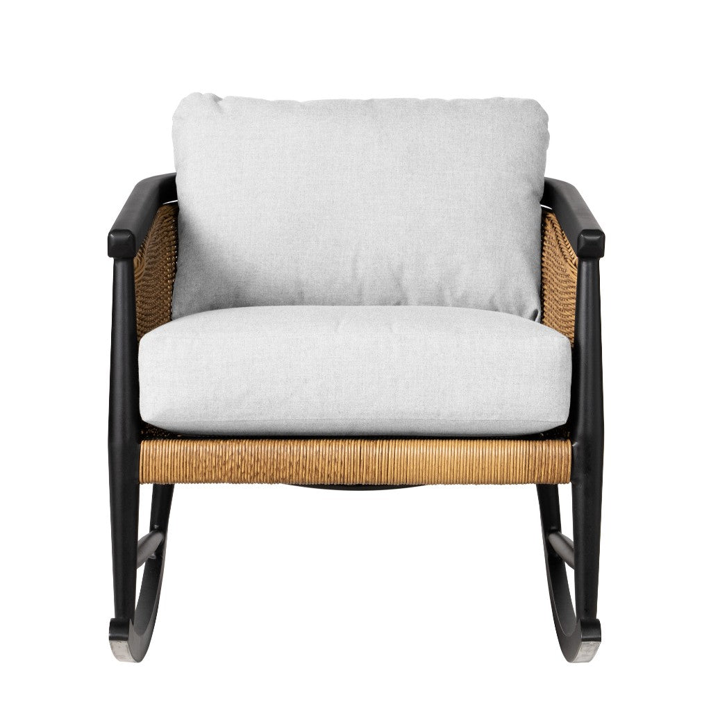 Rattan rocking chair with white cushions on a white background